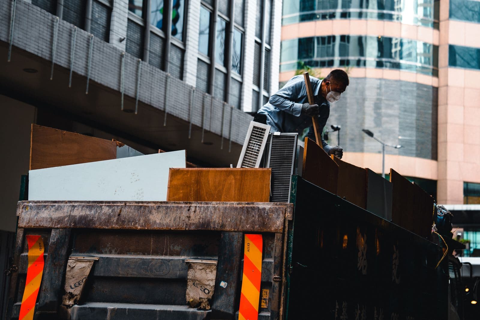 Worker loading debris onto a truck